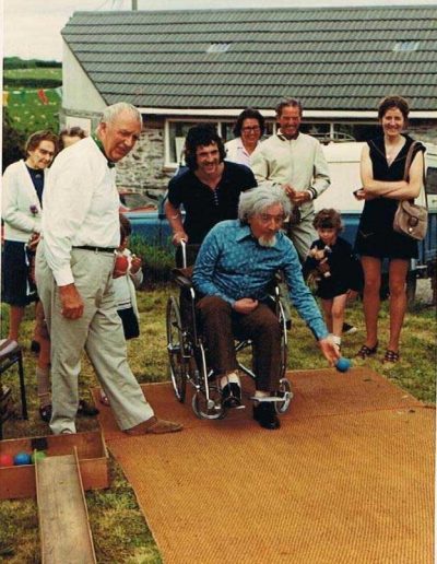 Prawle Fair Graham Fisher had bought Pigs Nose off John Ireland. Alan Knight in a wheelchair bowling on the small green opposite the shop, son in law behind, Jack Rendell at the side (Joan Bailey's father), 1970s