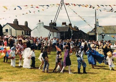 Prawle Fair in the 1970s, dancing round the may pole on Prawle green with the Corner Cottages, and Sunnyside in the picture; the children were walked round the village in fancy dress and then paraded round the village green while the judging took place
