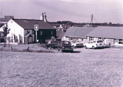Pig’s Nose Inn and Piglet stores. East Prawle green, 1960s or 1970s, Cars K registrations