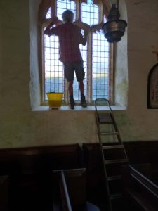 Johnie Parry cleaning the inside of windows